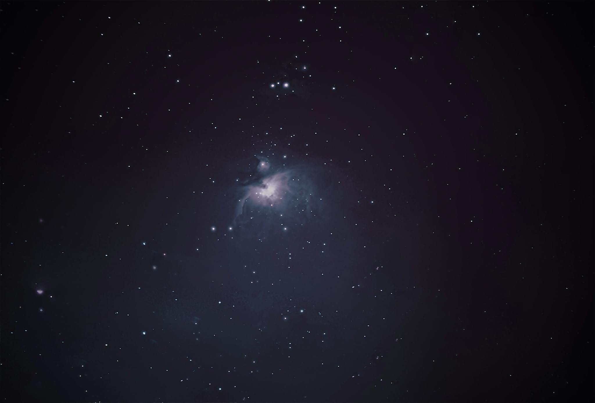 Stunning night sky view of Orion Nebula with bright stars.